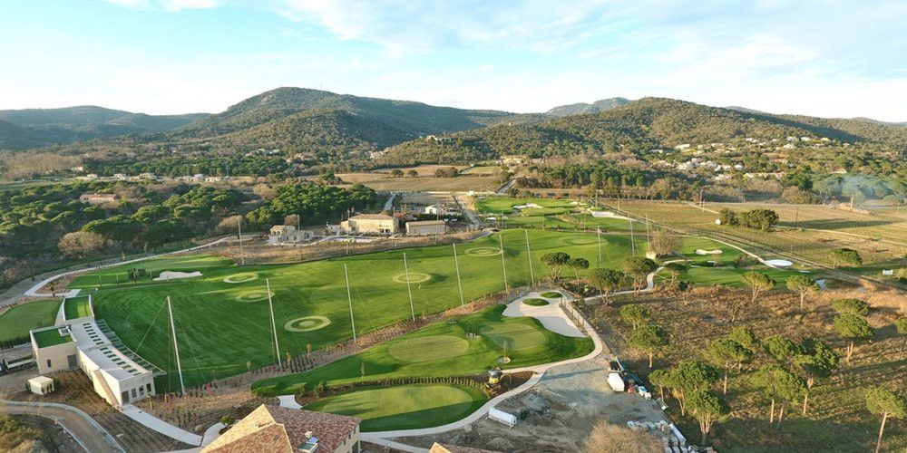 Vancouver Aerial view of a synthetic grass golf course surrounded by hills